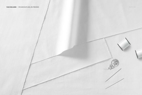 Fabric layers mockup showing overlapping white cloth sheets with sewing accessories placed on a neutral background.
