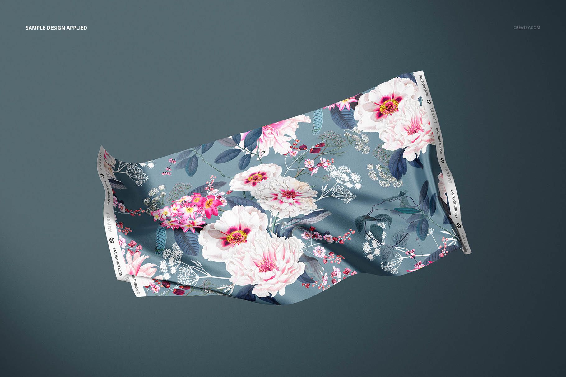 Silk fabric swatch with a floral pattern in pink and white tones on a blue background, shown in a front view mockup.