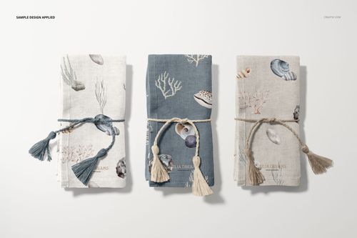 Cotton linen napkin PSD mockup set with marine motifs, neatly arranged in a row and accented with knotted tassel ropes.