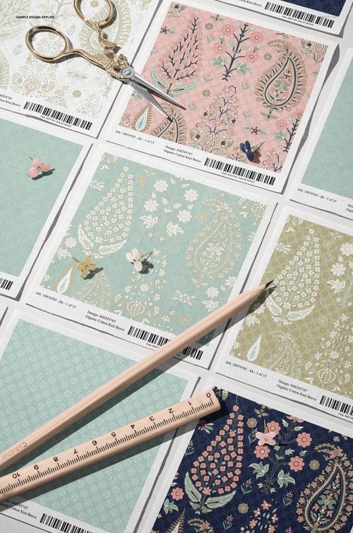 Angled view of cotton fabric swatches mockup featuring pastel floral and paisley patterns on square samples.
