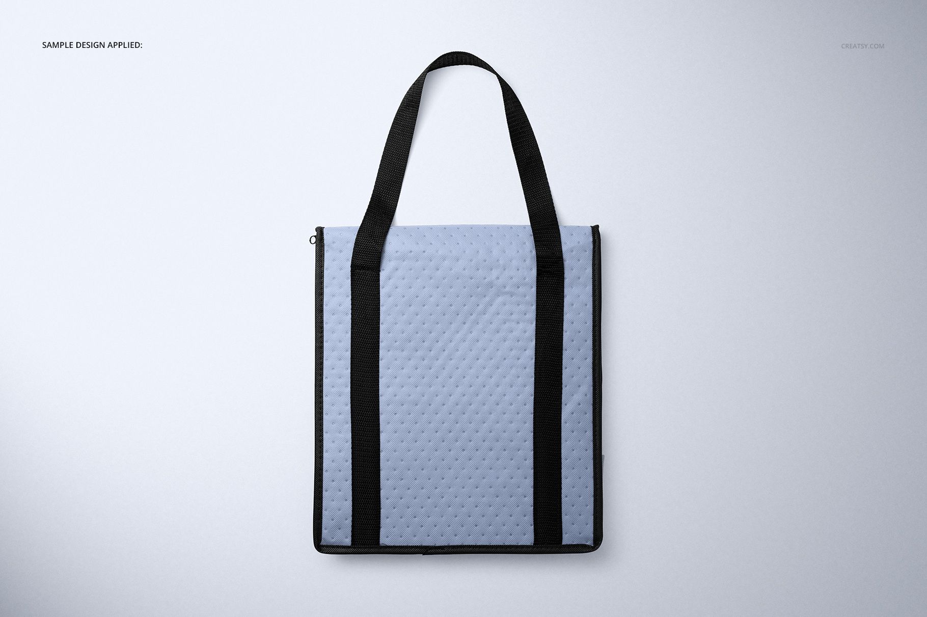 Front view of a square insulated cooler bag mockup with light blue textured surface and black handles on a plain background.