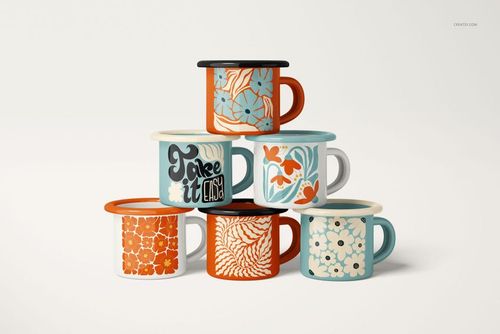 Stacked enamel mugs with floral and graphic patterns in orange, blue, and white, shown from a front view on a plain background.