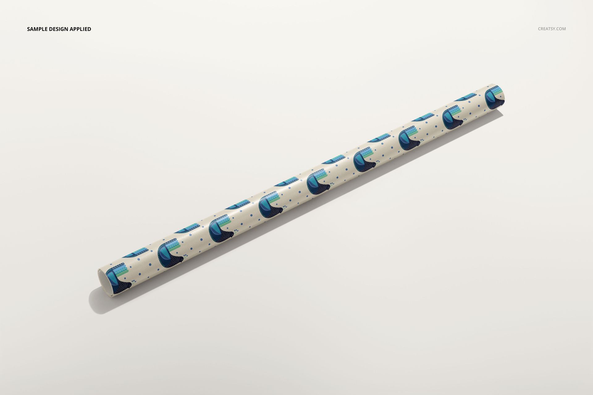 Gift wrapping paper PSD mockup roll with abstract blue shapes and small dots, photographed on a neutral background.