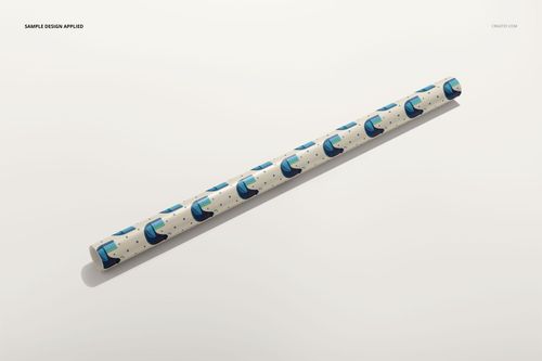 Gift wrapping paper PSD mockup roll with abstract blue shapes and small dots, photographed on a neutral background.