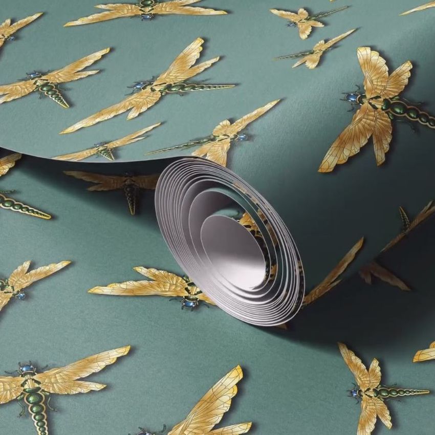 Paper wallpaper mockup featuring a rolled sheet with a repeating gold dragonfly pattern on a teal green background.