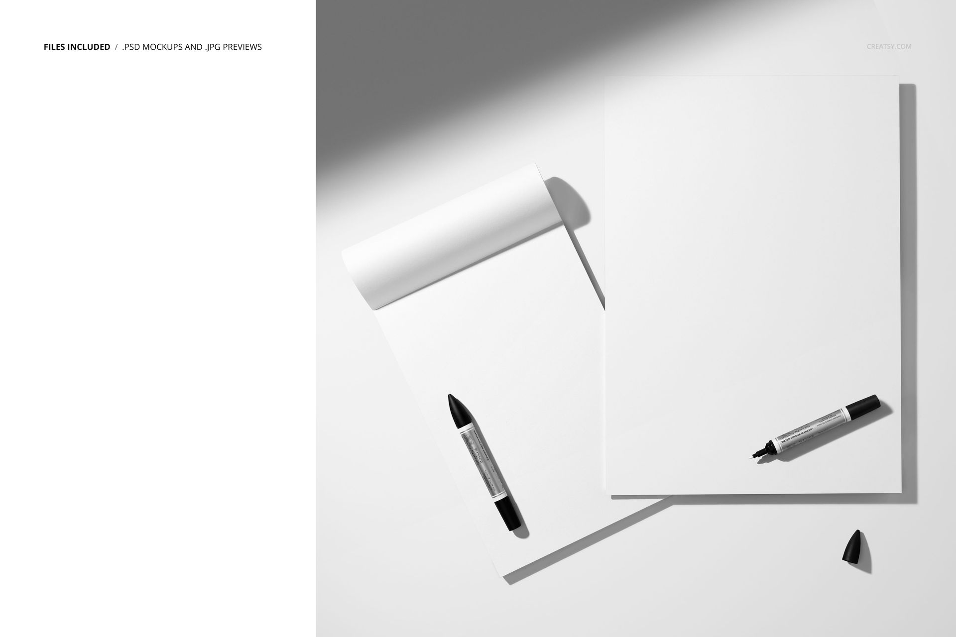 PSD mockup showing two empty sketch pads and markers, casting realistic shadows on a clean white background.