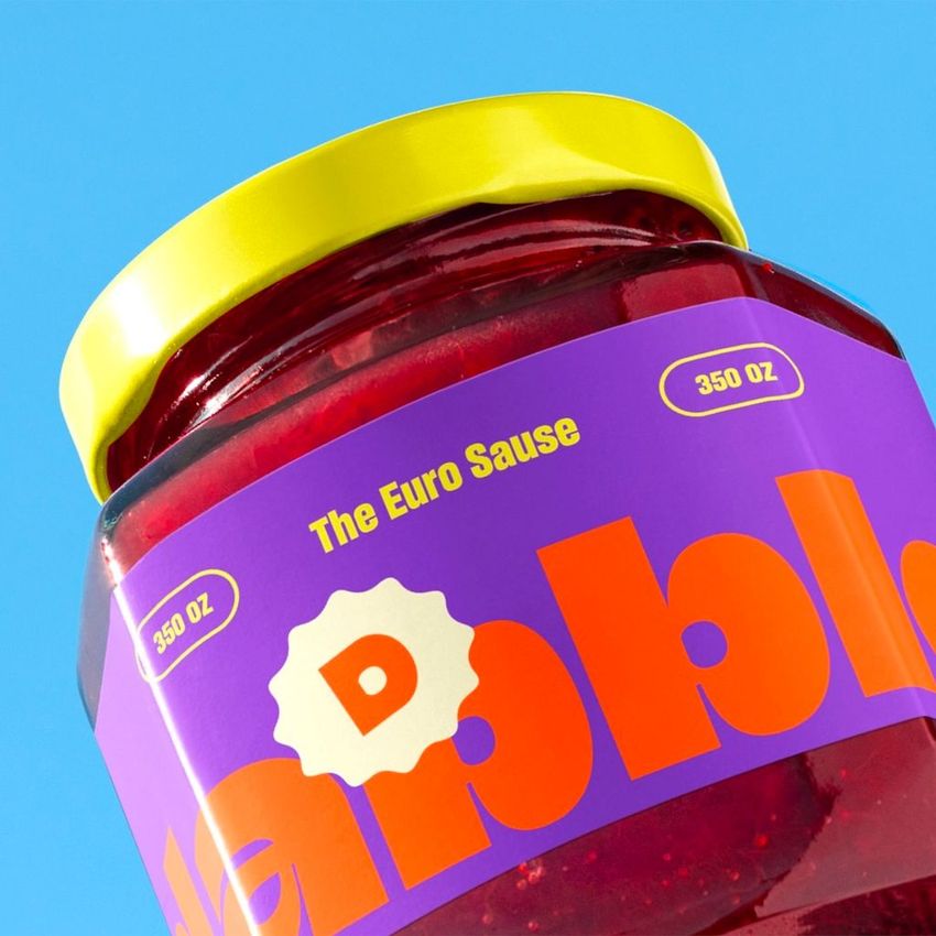 Strawberry jam jar mockup featuring a purple and orange label with bold text, yellow lid, and blue background.