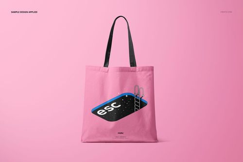 Pink tote bag mockup displayed from the front, showing a pool illustration with 'esc' lettering and black straps.