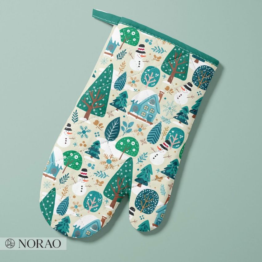 Oven mitt mockup featuring a winter forest pattern with trees, snowmen, and houses in green, blue, and beige on a pale background.