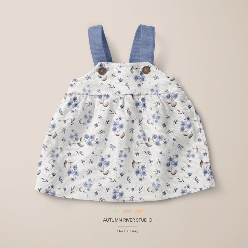 Baby dress mockup featuring a sleeveless dress with blue straps and a floral pattern, displayed on a beige background.