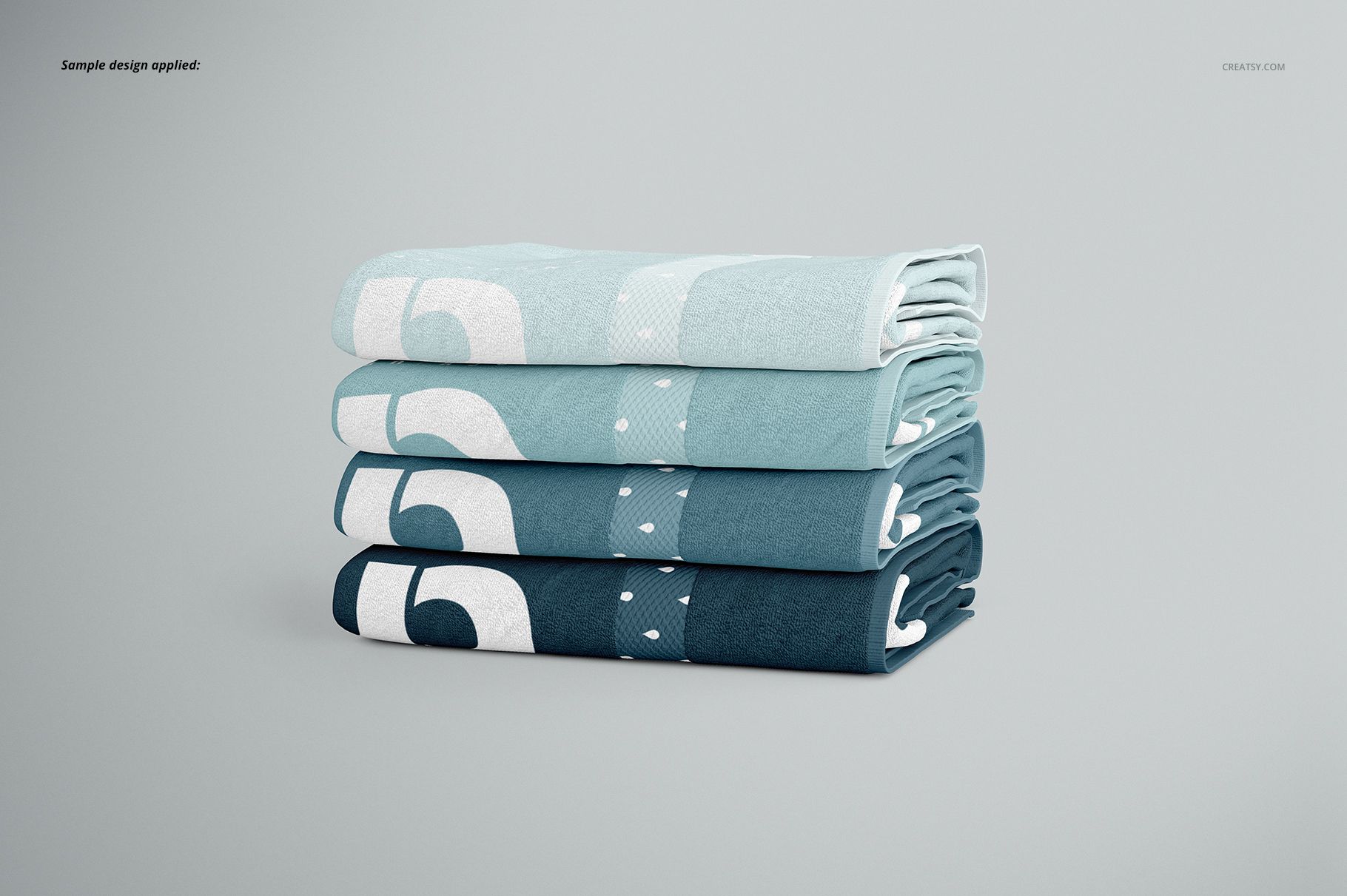 Bath towel PSD mockup set with layered towels in blue gradients and simple patterns, viewed from the side on a neutral surface.