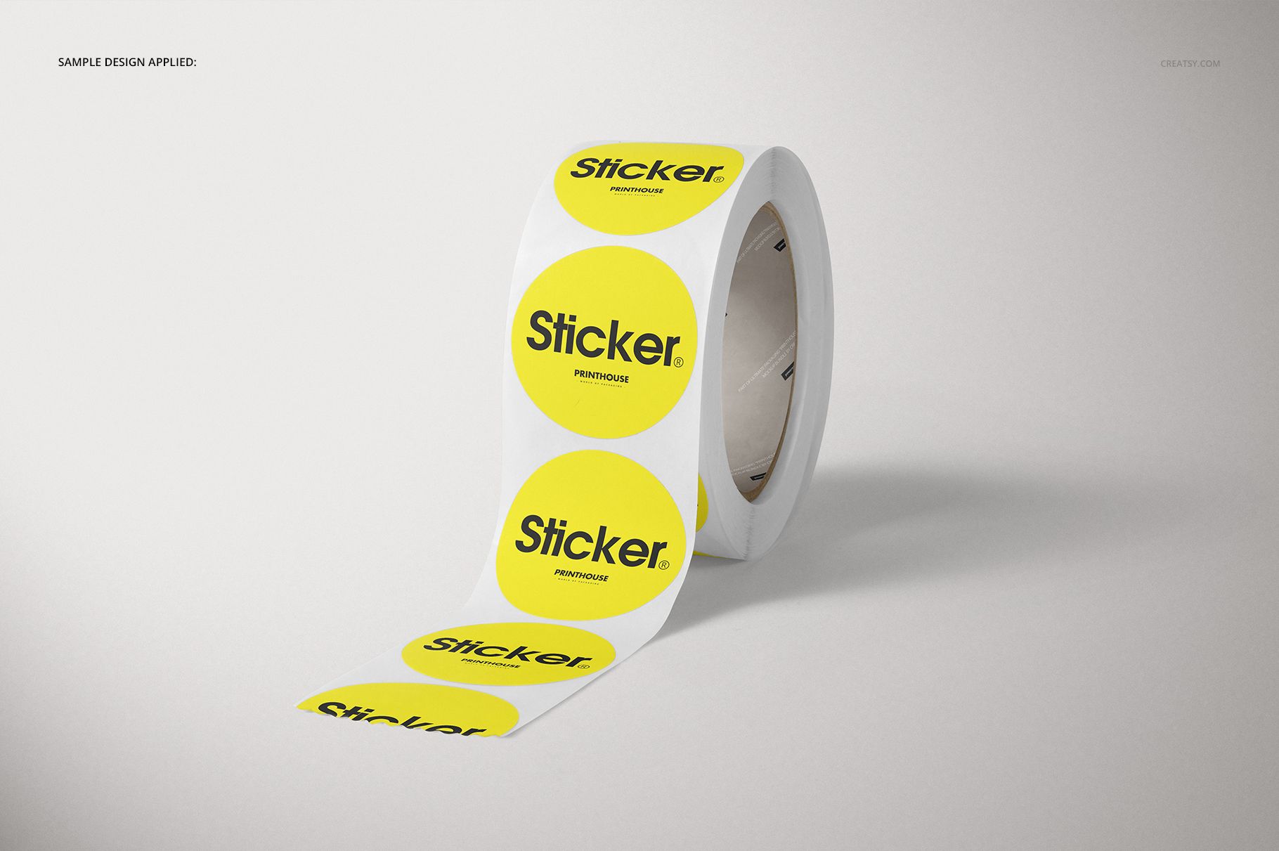 Round roll stickers mockup showing a strip of yellow circular stickers with text, presented on a simple surface.