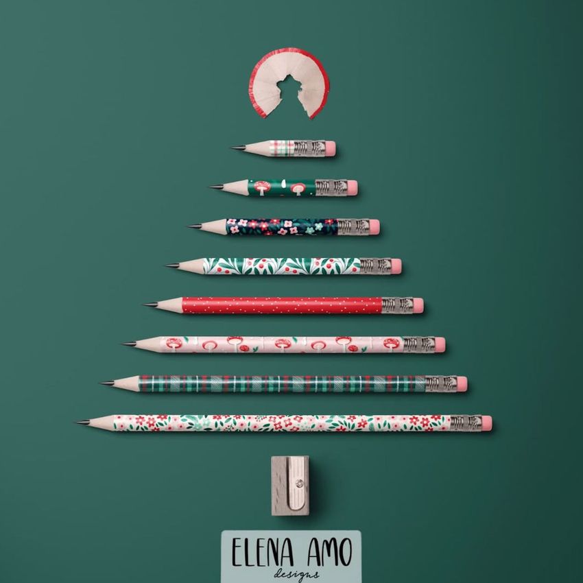 Pencil Christmas tree mockup featuring decorated pencils arranged in a tree shape on a green background with a pencil shaving as the star.
