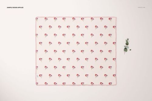 Swaddle blanket mockup featuring a rectangular cloth with a repeating floral pattern, viewed from above on a light surface.