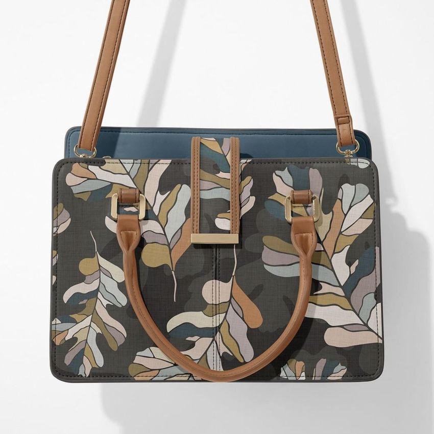 Leather handbag mockup featuring a leaf pattern in muted earth tones, shown from the front with tan shoulder straps on a white background.