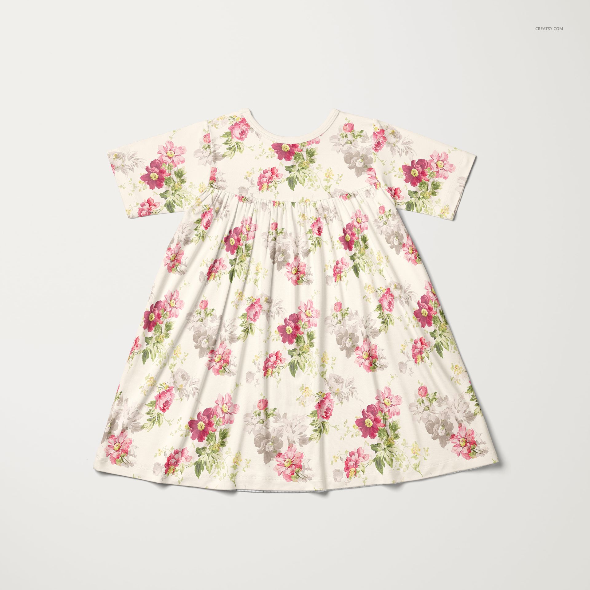 Short sleeve kids dress mockup featuring a vibrant floral print in pink and gray tones, shown from above on plain backdrop.