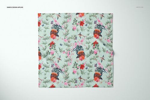 Furoshiki fabric mockup showing a flat square textile with birds, flowers, and greenery in a repeating pattern.