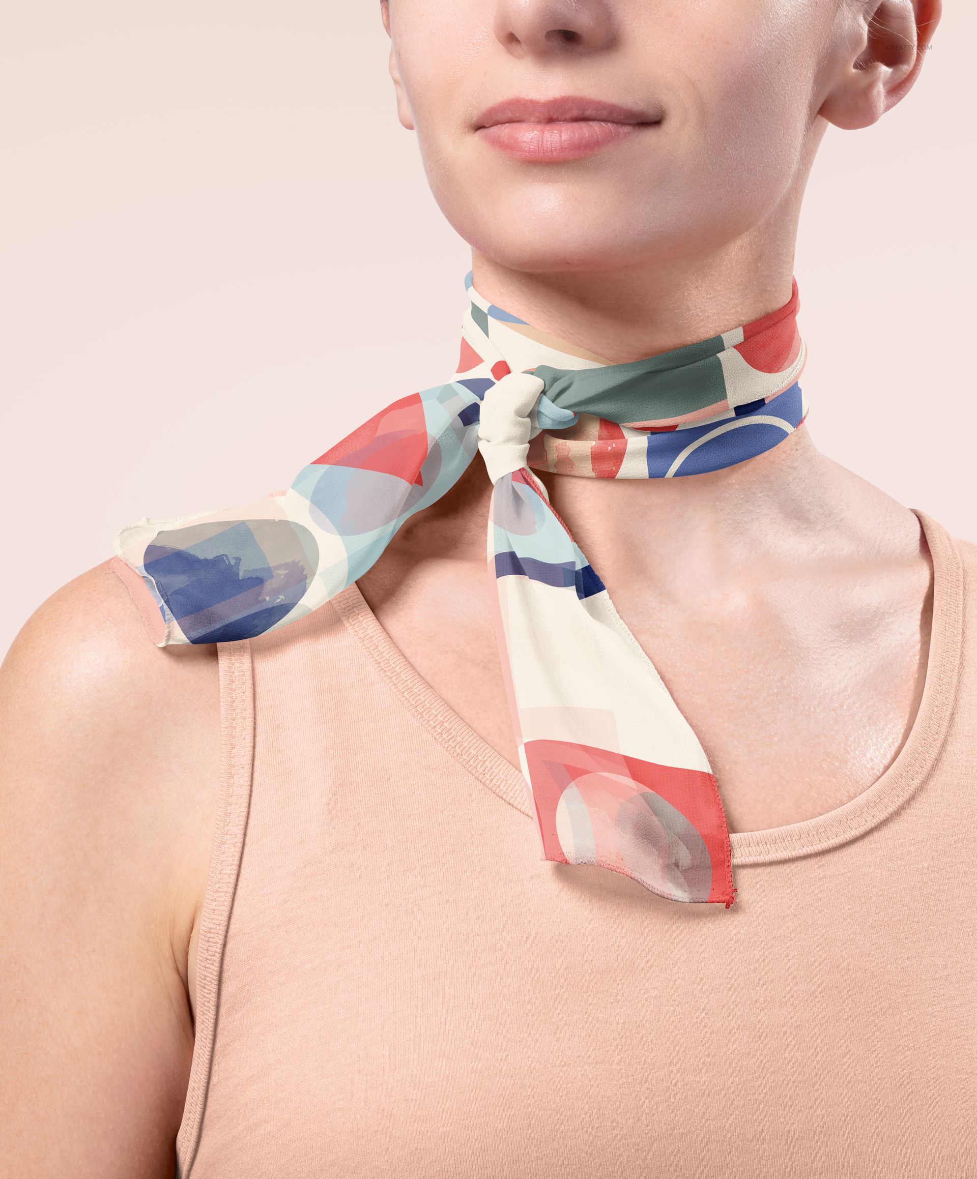 Front view of a model wearing a chiffon silk scarf with abstract geometric patterns in red, blue, and cream tones.