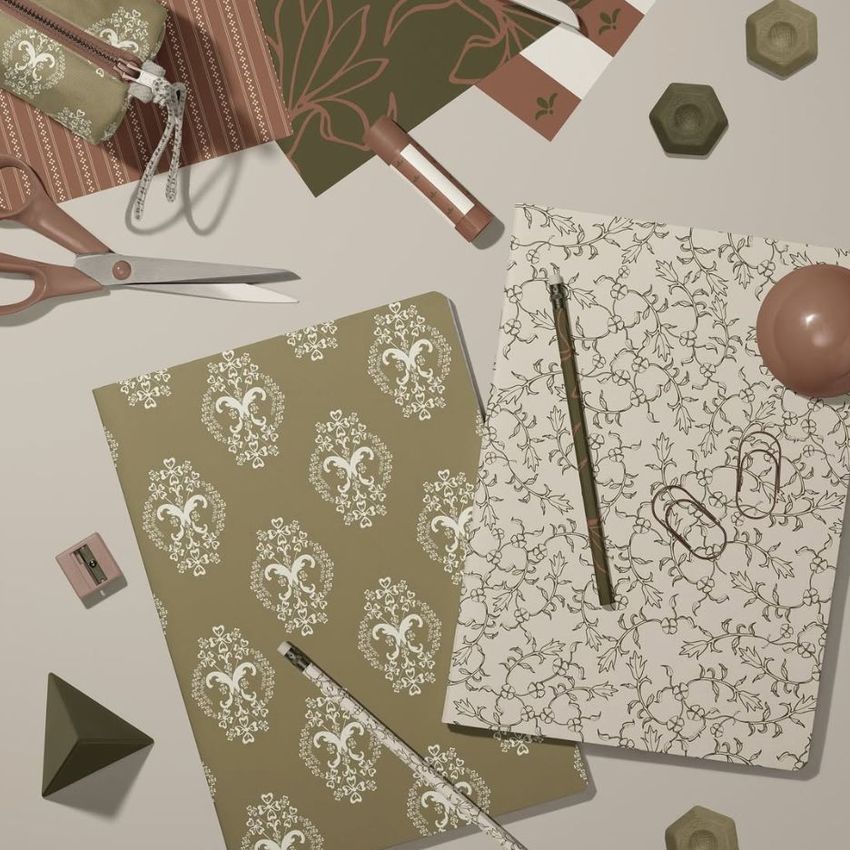 Stationery mockup featuring two classic A4 notebooks with floral and damask covers, surrounded by scissors, pens, and paper clips.