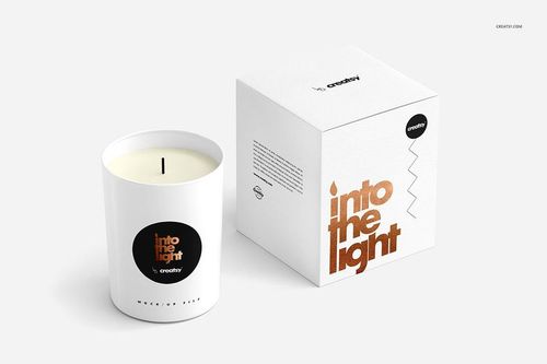 Scented candle mockup featuring a white glass candle and a coordinating box with bold metallic text and minimal graphics.