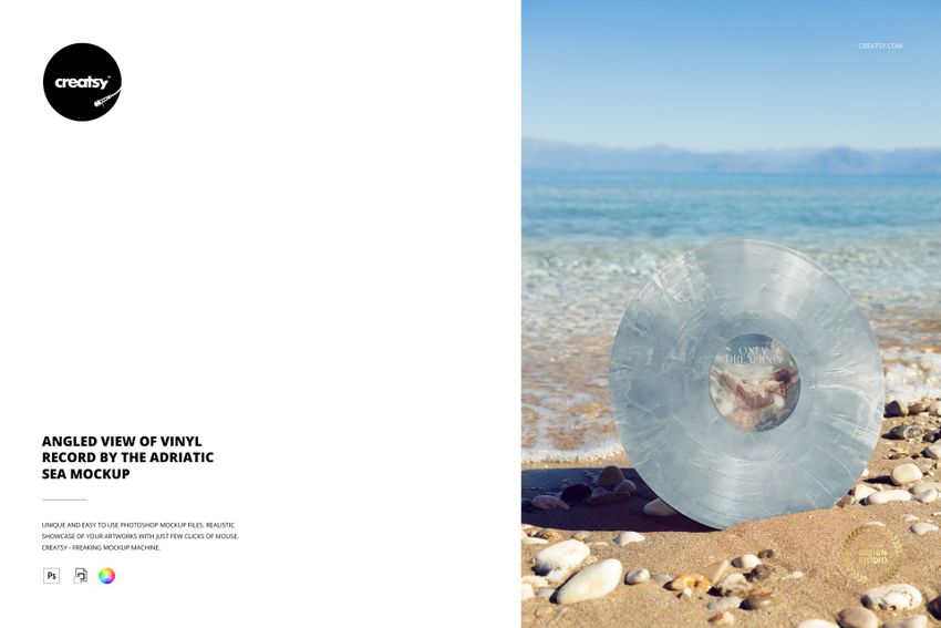Transparent vinyl record mockup positioned on pebbles by the Adriatic coastline, with water and horizon visible.