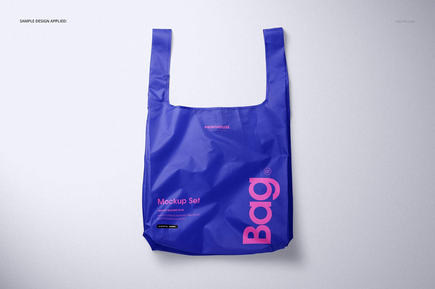 Blue ripstop reusable bag mockup shown from the front, featuring bold pink lettering and a plain backdrop.