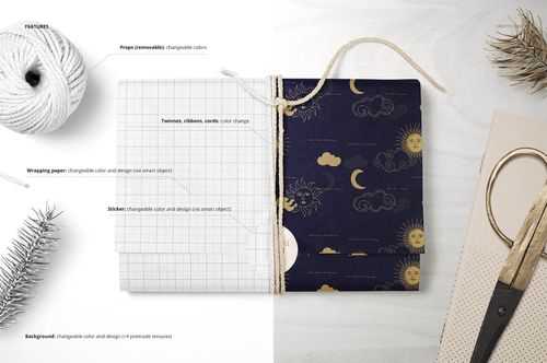 Gift wrapping tissue paper mockup set showing folded paper with gold and navy pattern, twine, and scissors on a table.