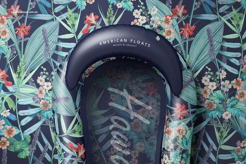 Top view of a mockup inflatable pool lounger float with dark blue edges and vibrant botanical patterns on the surface.