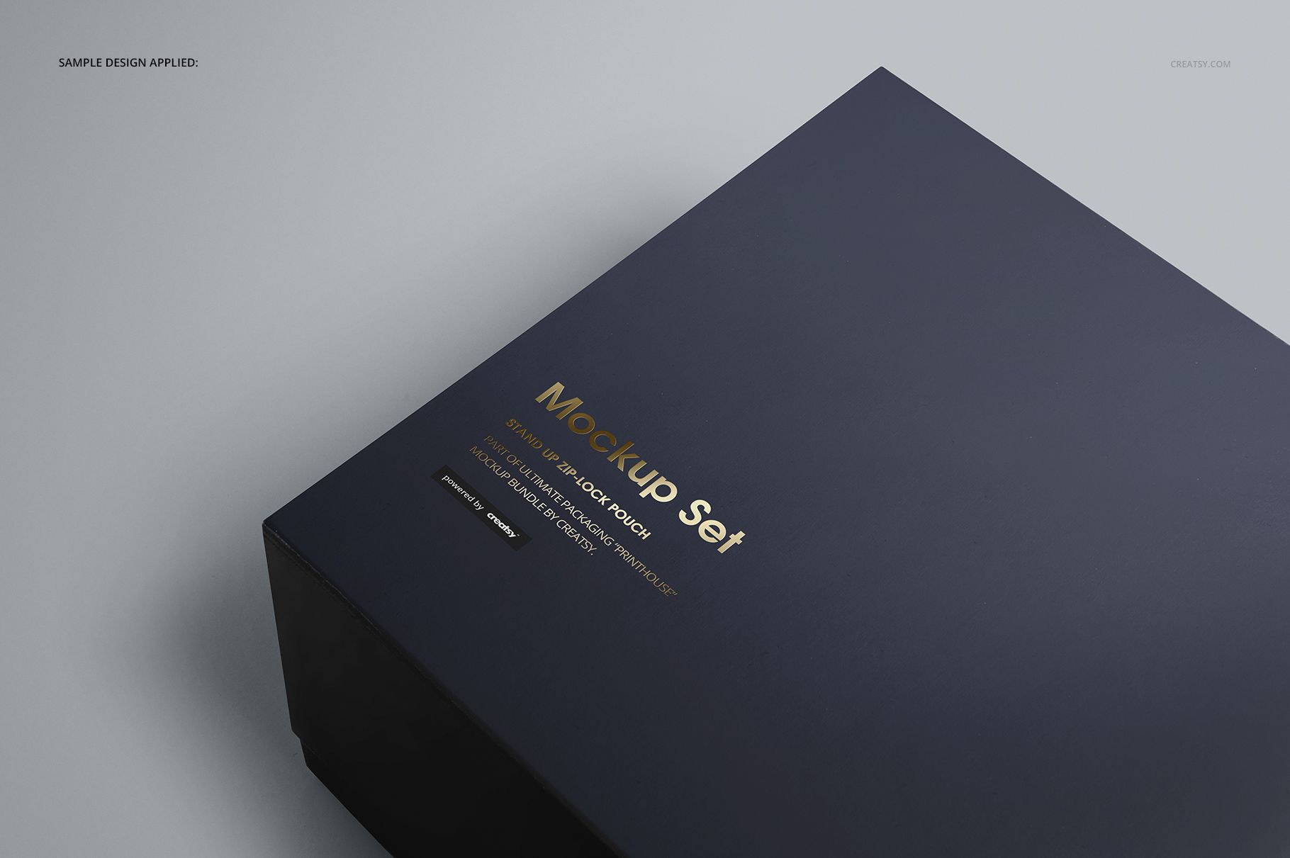 Magnetic gift box mockup featuring a sleek dark surface, viewed from above with gold text and minimal shadows.