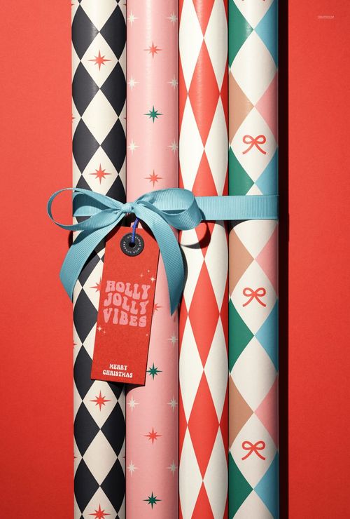 Christmas gift wrapping paper mockup featuring diamond and star patterns, arranged vertically on a red background.