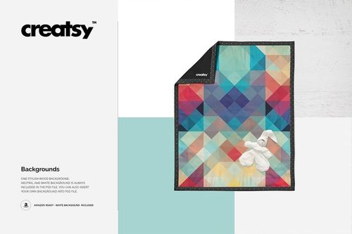 Colorful geometric baby quilt mockup displayed on a light background, featuring a plush bunny toy on top.