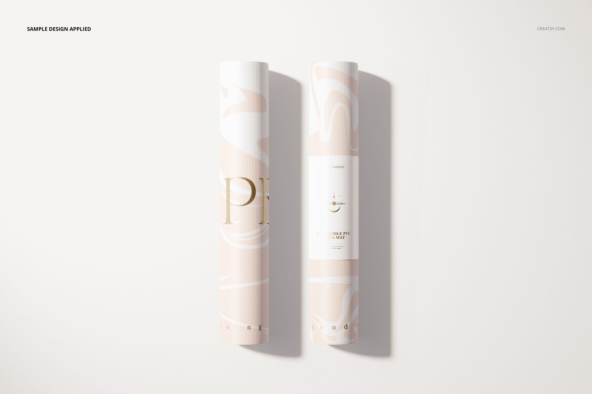 Rolled yoga mat mockup featuring soft pink and white swirls, shown from a top view on a neutral surface.