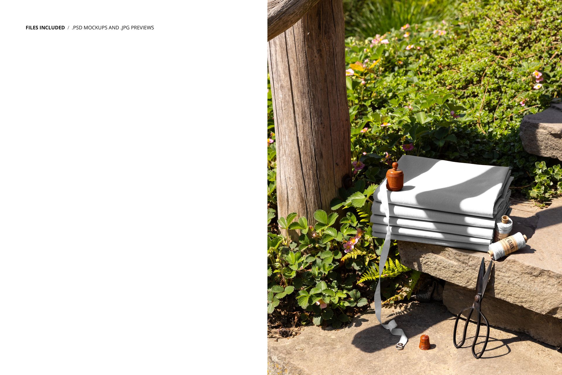 PSD mockup showing a pile of neatly folded fabric on rustic garden steps, accompanied by sewing accessories and foliage.