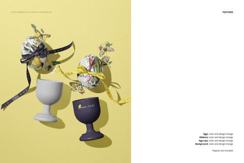 PSD mockup showing two Easter eggs with botanical designs and butterflies, set in egg holders with colorful ribbons.