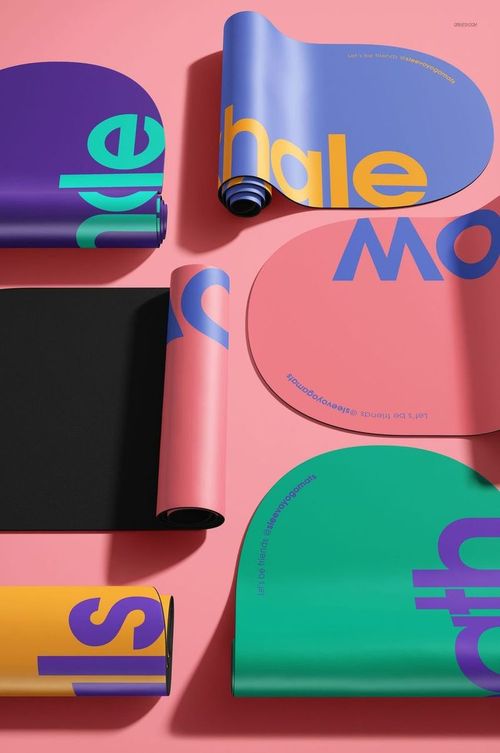 PSD mockup of oval yoga mats featuring graphic text designs and colorful surfaces, arranged on a pink backdrop.