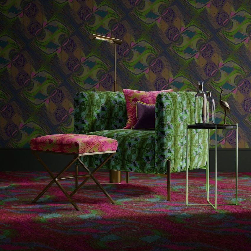 Velvet armchair and matching stool mockup in a living room with bold green and pink patterns, side table, and decorative vases.