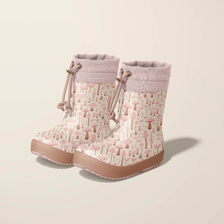 Two children's rain boots mockup with a pink and beige mushroom pattern, shown on a light neutral background with soft shadows.