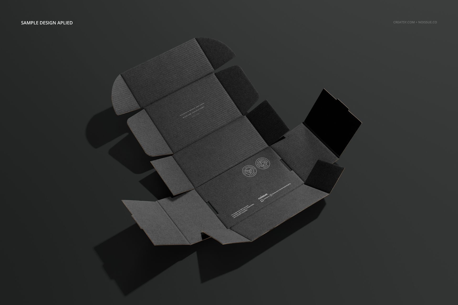 Flat lay view of a dark gray mailing box mockup with folded edges and subtle printed design elements on a neutral background.