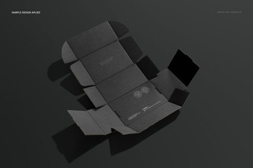 Flat lay view of a dark gray mailing box mockup with folded edges and subtle printed design elements on a neutral background.