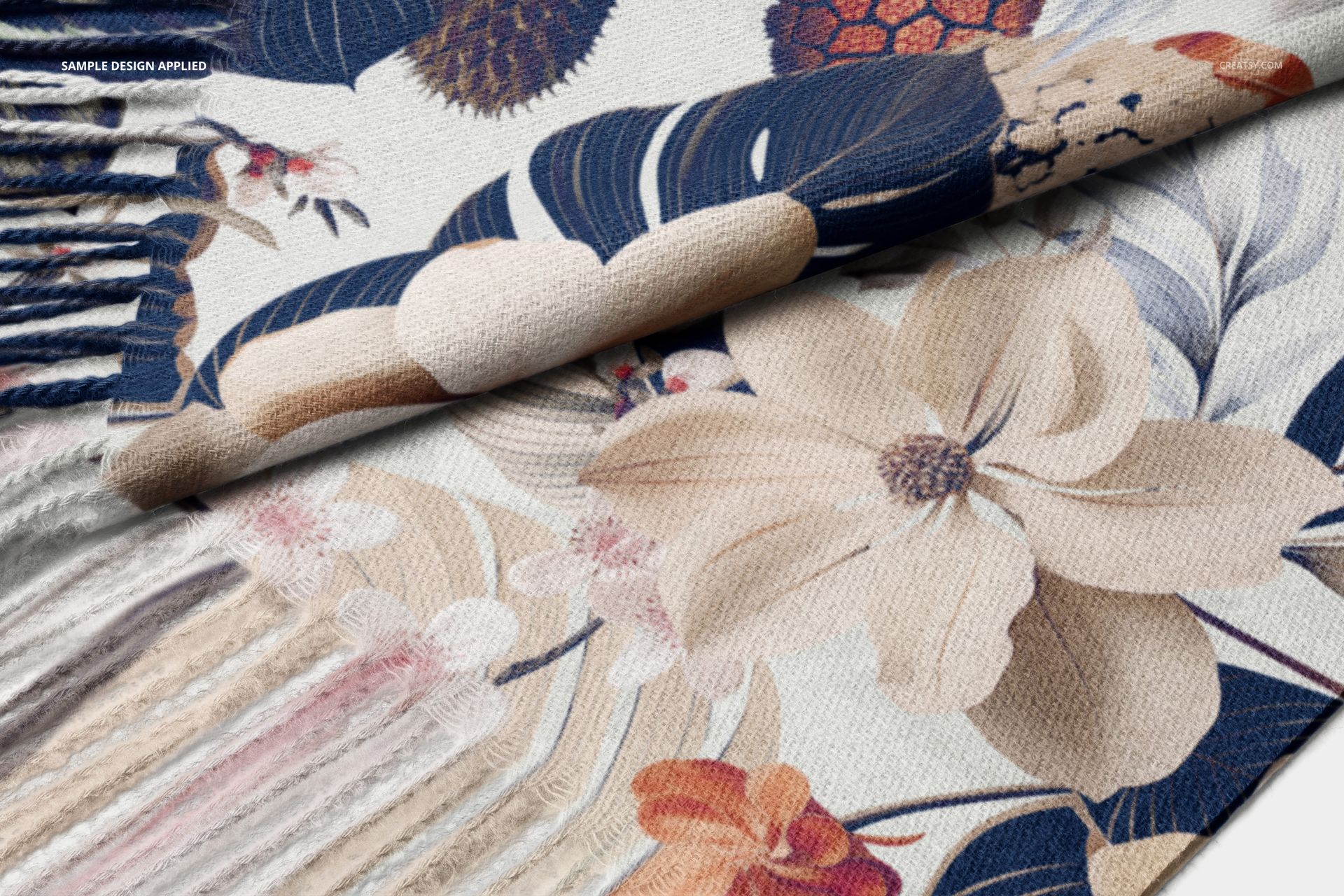 Cashmere scarf featuring a large floral pattern in beige, navy, and brown tones, shown in a close-up view.
