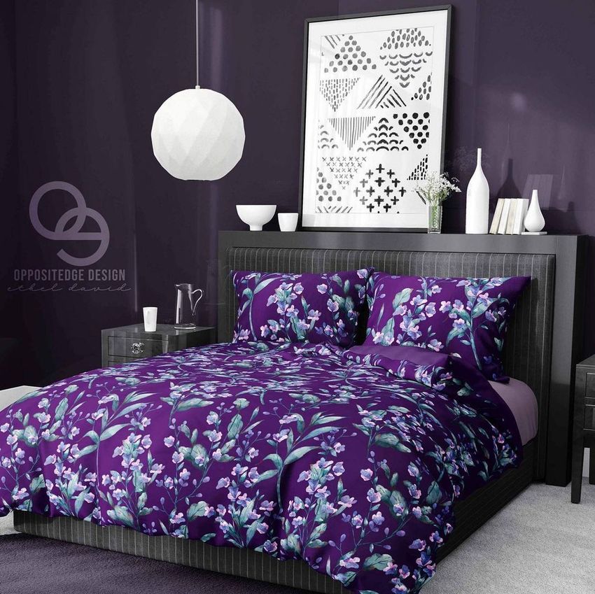 Bedding mockup featuring a purple comforter and pillows with a floral pattern on a modern bed in a dark purple bedroom.