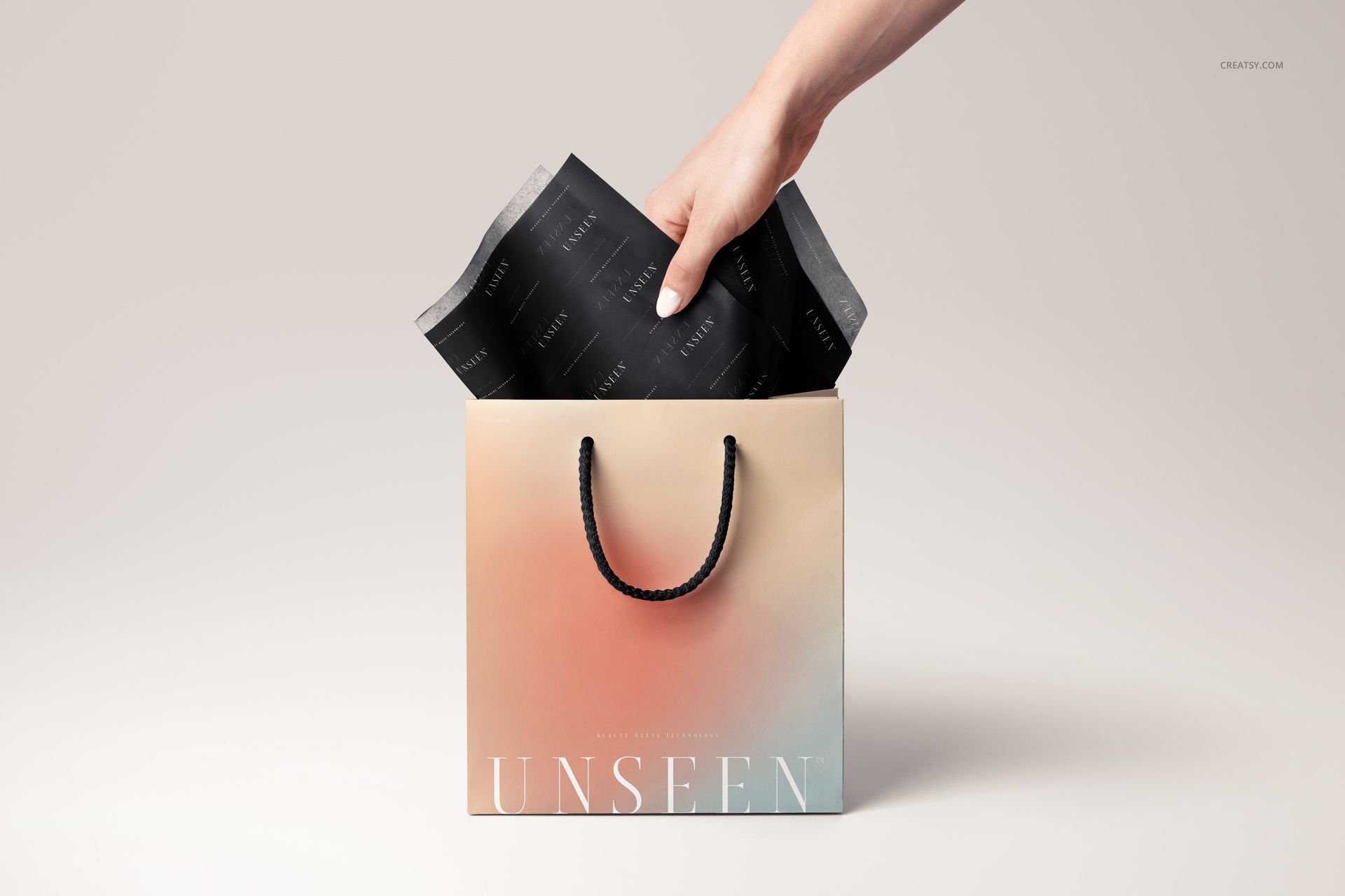 PSD mockup featuring a gift bag with black decorative tissue paper and rope handles, viewed from the front.