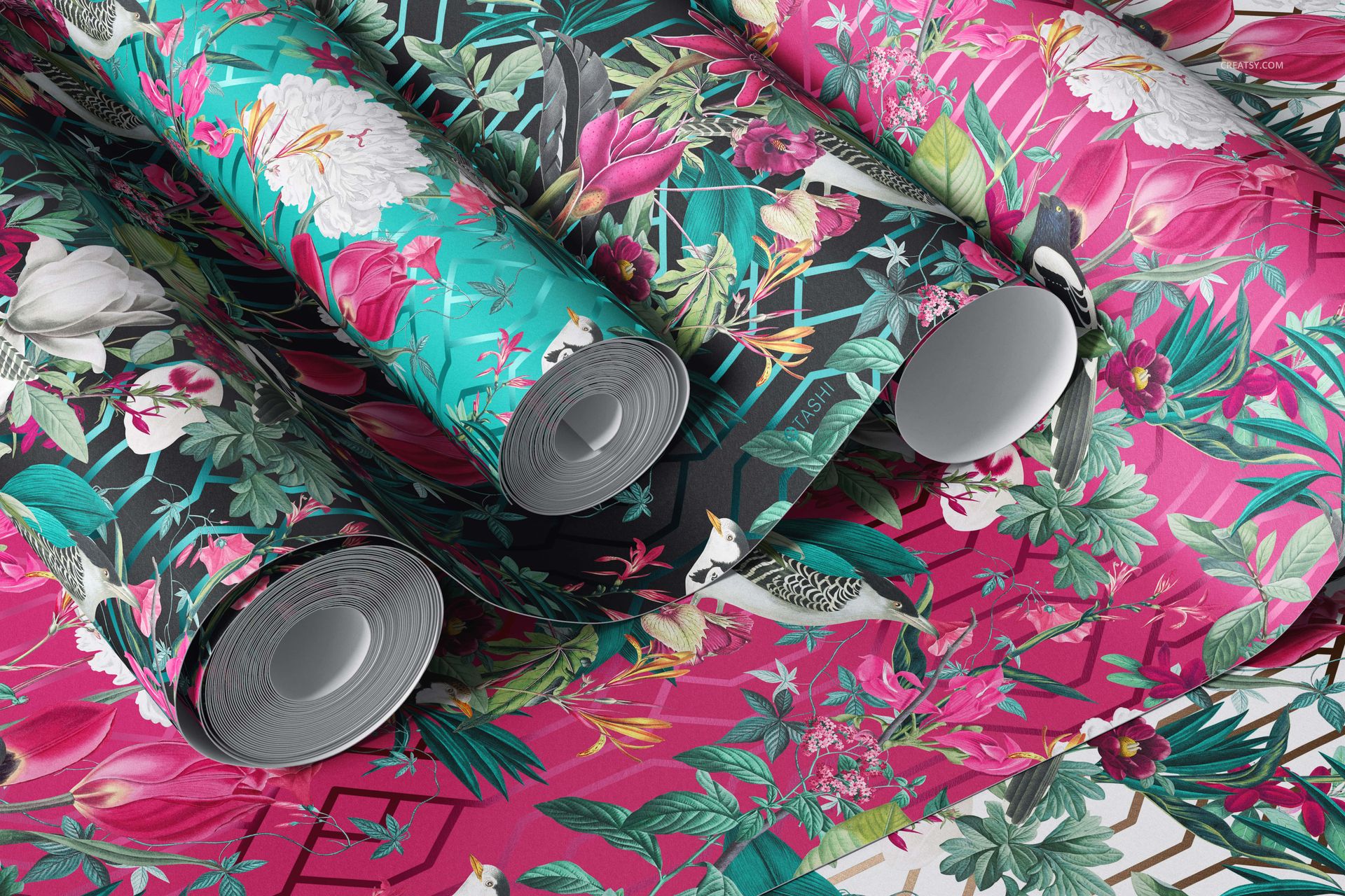 PSD mockup showing multiple paper wallpaper rolls with tropical floral motifs in bright and contrasting colors.