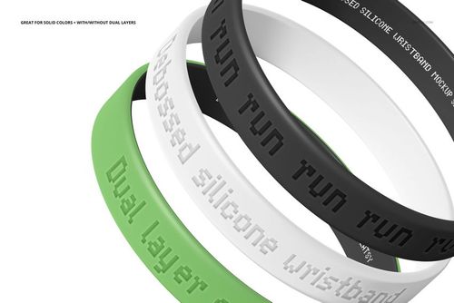PSD mockup of silicone wristbands featuring debossed lettering, arranged in a layered composition on a white background.