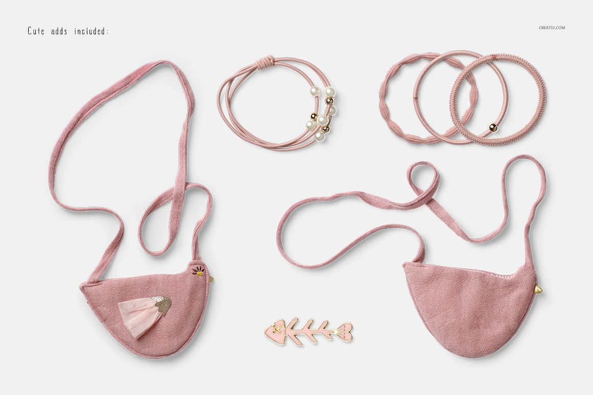 Front view of a baby blouse and shorts mockup set in soft pink fabric, displayed with matching accessories on a white background.