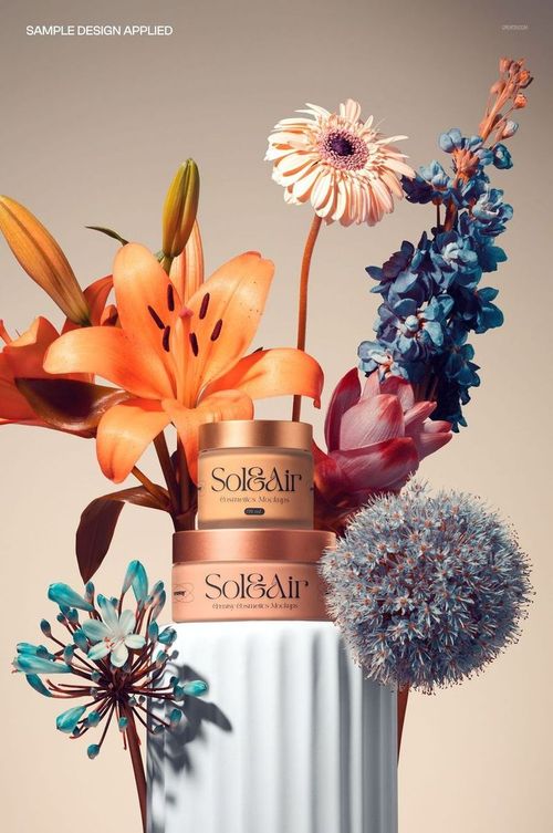 PSD mockup featuring two gold cosmetic jars placed on a ribbed white pedestal, with assorted colorful flowers around.