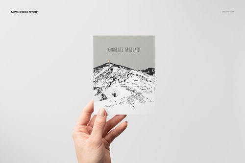 A2 card mockup with a simple mountain pattern and congratulatory text, held up by a hand on a neutral backdrop.