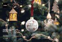 Handmade bone china bauble mockup featuring a festive design, velvet ribbon, and pine tree background with wooden decorations.