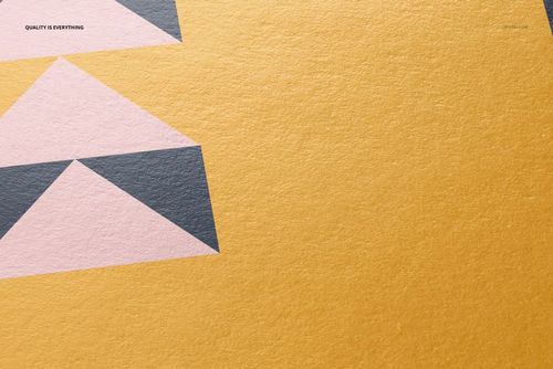 Detailed view of a mockup print on cotton paper featuring pink and gray triangles on a yellow surface.