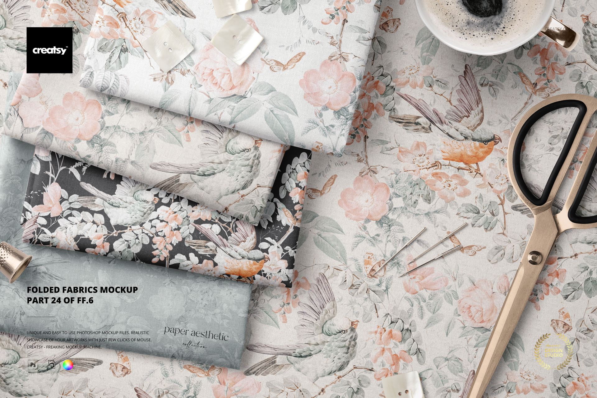 PSD mockup showing folded textiles in soft colors and botanical prints, arranged with scissors and decorative props.